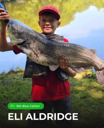 Young angler Eli Aldridge holding a trophy Big Blue Catfish caught with a Catch the Fever Big Cat Fever rod