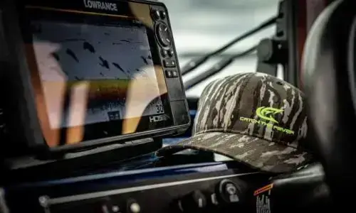Catch the Fever camouflage hat on a Lowrance fishfinder console – outdoor fishing apparel and accessories